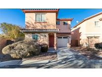 Two-story house with attached garage and landscaping at 3396 Villa Fiori Ave, Las Vegas, NV 89141