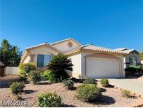 One-story house with a two-car garage and landscaped front yard at 43 Pangloss St, Henderson, NV 89002