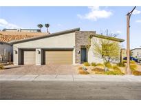 Modern two-car garage home with stone accents and landscaping at 52 Reverie Heights Ave, Henderson, NV 89011