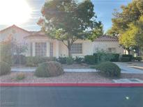 Single-story house with red tile roof, landscaping, and a walkway at 5400 Paul Kurtz Way # 102, Las Vegas, NV 89108