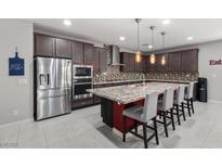 Spacious kitchen with stainless steel appliances and granite countertops at 6331 Regina Ridge St, Las Vegas, NV 89149