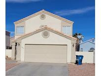 Two-story house with attached garage and desert landscaping at , Las Vegas, NV 89145