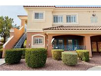 Two-story building with multiple units, featuring a staircase and landscaping at 10553 Pine Glen Ave # 202, Las Vegas, NV 89144