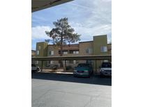 Tan two-story building with covered parking and landscaping at 1826 N Decatur Blvd # 101, Las Vegas, NV 89108