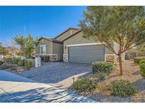 Single-story house with gray siding, stone accents, and a two-car garage at 393 Mullen Ave, Henderson, NV 89044