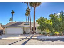 House exterior featuring a two-car garage and well-manicured landscaping at 4025 Ridgewood Ave, Las Vegas, NV 89120