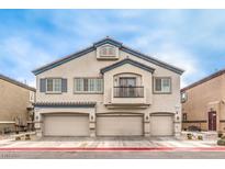 Two-story townhome boasting three-car garage, balcony, and charming curb appeal at 4635 Ridgeley Ave # 101, North Las Vegas, NV 89084