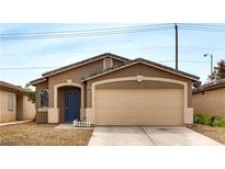 One-story house with tan exterior, blue door, and attached garage at 5675 Halvern Ave, Las Vegas, NV 89110