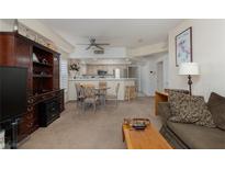 Inviting living room featuring an open floorplan with a ceiling fan, plush seating, and adjacent dining area and kitchen at 6701 Dorita Ave # 201, Las Vegas, NV 89108