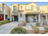 Two-story house with balcony, porch, and attached garage at 9068 Alluring Ave, Las Vegas, NV 89149