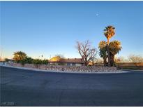Ranch style home with stone wall and mature landscaping at 1808 Loch Lomond Way, Las Vegas, NV 89102