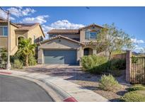 Two-story house with gray garage door and landscaping at 25 Via Corvina, Henderson, NV 89011