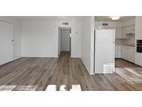 Bright living room with hardwood floors and access to other rooms at 350 E Desert Inn Rd # H208, Las Vegas, NV 89109