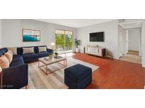 Bright living room featuring a comfy sectional sofa and wood flooring at 4380 Sandy River Dr # 36, Las Vegas, NV 89103
