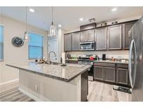 Modern kitchen with stainless steel appliances and an island at 495 Granite Arch St, Las Vegas, NV 89138