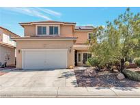 Two-story house with a white garage door and landscaping at 6516 Starling Mesa St, North Las Vegas, NV 89086