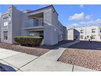 Gray two-story building with walkway, landscaping, and adjacent building visible at 6800 E Lake Mead Blvd # 2028, Las Vegas, NV 89156