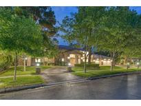 Elegant two-story home with a beautifully landscaped yard and a long driveway at 105 Quail Run Rd, Henderson, NV 89014
