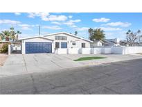 Modern home exterior with blue garage doors and white brick at 1313 Bonita Ave, Las Vegas, NV 89104