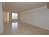 Bright living room features neutral paint, and sleek tile flooring for a modern and clean aesthetic at 270 E Flamingo Rd # 211, Las Vegas, NV 89169