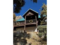 Log cabin home with a wrap-around deck and mountain views at 302 Kris Kringle Rd, Las Vegas, NV 89124