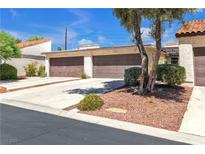 Two-car garage with driveway and landscaping at 3140 Pradera Cir, Las Vegas, NV 89121