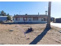 Modest single-story house on a large lot with desert landscaping and limited improvements at 3748 Skyline St, Logandale, NV 89021