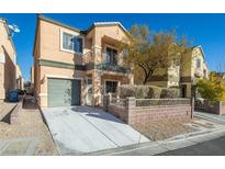 Two-story house with attached garage and landscaped front yard at 10516 Blanca Peak Ave, Las Vegas, NV 89129