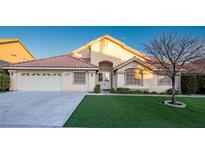 Beautiful single-story home with a well-manicured lawn and a two-car garage at 1240 Honey Lake St, Las Vegas, NV 89110