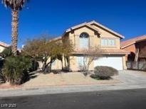 Two-story house with a landscaped yard and attached garage at 1628 Rio Bravo Dr, North Las Vegas, NV 89031