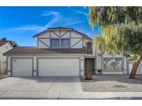 Two-story house with a three-car garage and landscaped yard at 2101 Autumn Lull Dr, Las Vegas, NV 89146