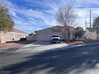 Single-story house with a two-car garage and landscaped front yard at 5921 Negril Ave, Las Vegas, NV 89130