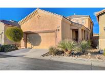 Two-story house with attached garage and desert landscaping at 8856 Ashley Park Ave, Las Vegas, NV 89148