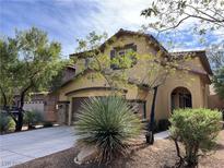 Two-story house with attached garage and desert landscaping at 9161 Horizon Mist Ave, Las Vegas, NV 89178