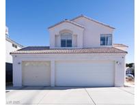 Two-story house with a two-car garage and landscaped yard at 1429 Daybreak Dr, Las Vegas, NV 89108