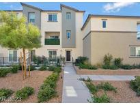 Modern three-story townhome with landscaped front yard and walkway at 2844 Copper Wind Ln # 4, Las Vegas, NV 89183