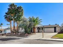 Ranch style home with mature landscaping and a two-car garage at 4457 Dennis Way, Las Vegas, NV 89121