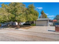 Single-story house with a large tree and driveway at 4850 Aveneda Grande, Las Vegas, NV 89121