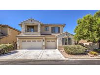 Two-story house with a three-car garage and landscaped front yard at 7525 Royal Crystal St, Las Vegas, NV 89149