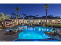 Luxury estate with a large, freeform pool and spa at night at 9390 Stange Ave, Las Vegas, NV 89129