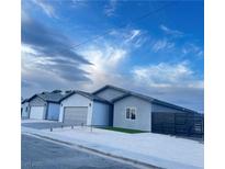 Newly constructed home with modern gray exterior and two-car garage at 1308 E Nelson Ave, North Las Vegas, NV 89030