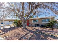 Ranch house with red door, carport, and landscaped front yard at 2828 Richfield Blvd, Las Vegas, NV 89102