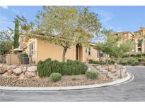 Tan two-story home with landscaped yard and stone accents at 4 Via Centrale # 1, Henderson, NV 89011