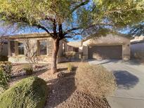 Single-story home with mature landscaping and a two-car garage at 5932 Quintillion Ave, Las Vegas, NV 89122