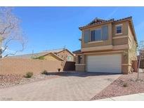 Tan two-story house with attached garage and landscaped front yard at 772 Crimson Peak Pl, Henderson, NV 89011