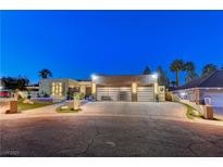 Luxury home with modern design, showcasing a spacious driveway and landscape at 8104 Via Del Cerro Ct, Las Vegas, NV 89117