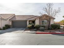 Single-story home with attached garage and well-manicured landscaping at 8634 Lakota St, Las Vegas, NV 89123