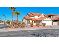 Two-story house with a red tile roof, two palm trees, and a white garage door at 2436 Millcroft Dr, Henderson, NV 89074