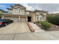 Two-story house with attached two-car garage and landscaped front yard at 2438 Ping Drive, Henderson, NV 89074