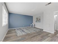 Neutral living room with a decorative rug, blue accent wall and light gray walls at 3801 Daisy St # 42, Las Vegas, NV 89119
